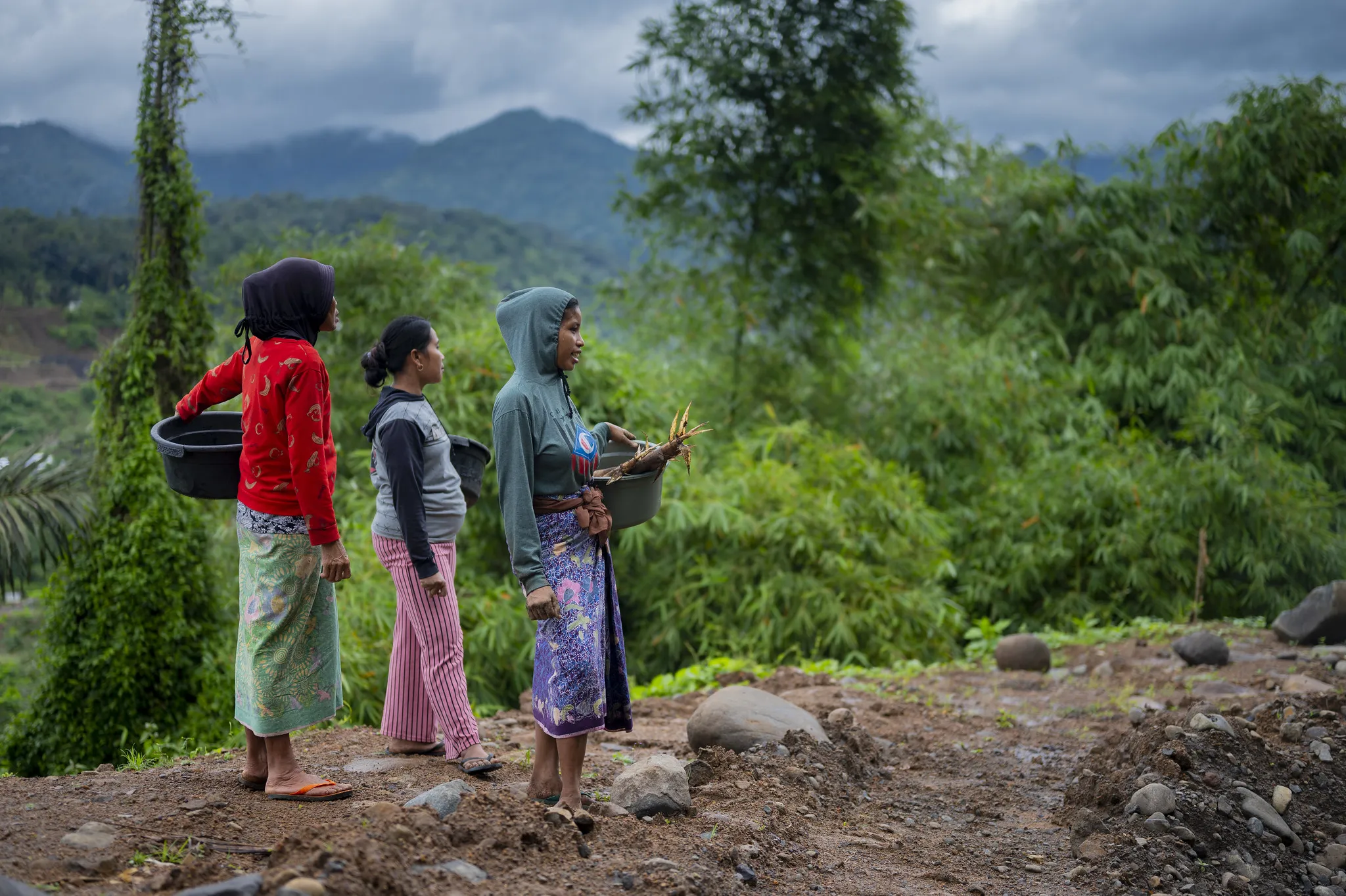 Three women walking on a ridge